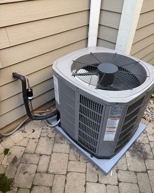 New outdoor air conditioner on a brick patio